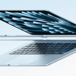 Sleek silver MacBook shown open at an angle on a light blue background.