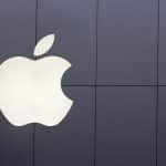 White Apple logo on a dark wall.