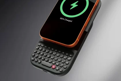 MagSafe keyboard battery attached to a smartphone with physical keys.