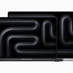 Two MacBook Pro laptops with dark screens.