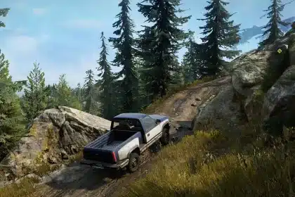 Off-road truck driving through a forest trail in SnowRunner.