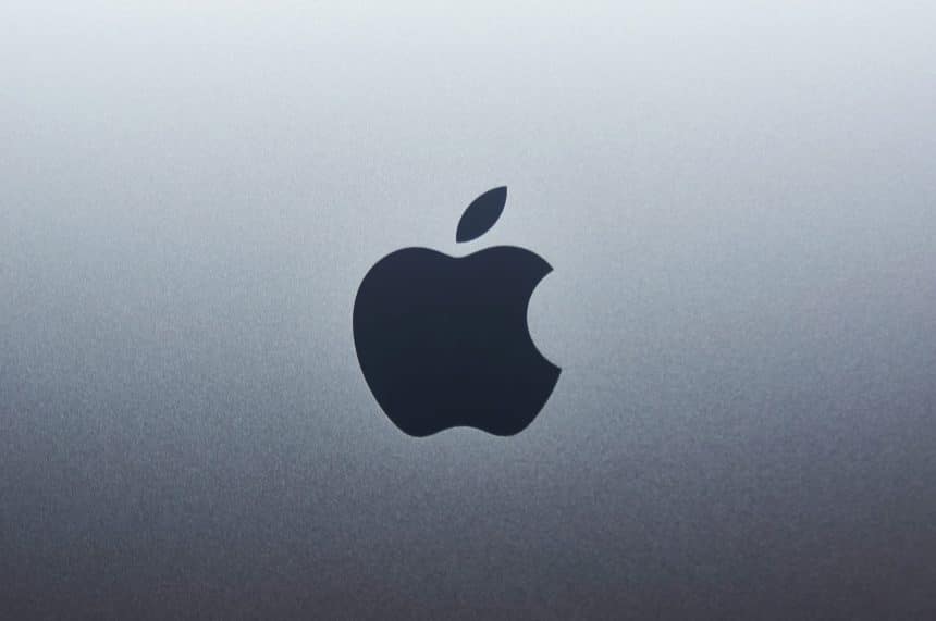 Apple logo on a metallic background.