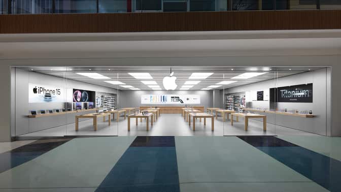 Apple Store interior with product displays and tables.