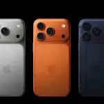 Three iPhones shown from the back in silver, orange, and dark blue colors.