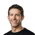 Portrait of a smiling man against a white background.