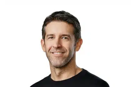 Portrait of a smiling man against a white background.