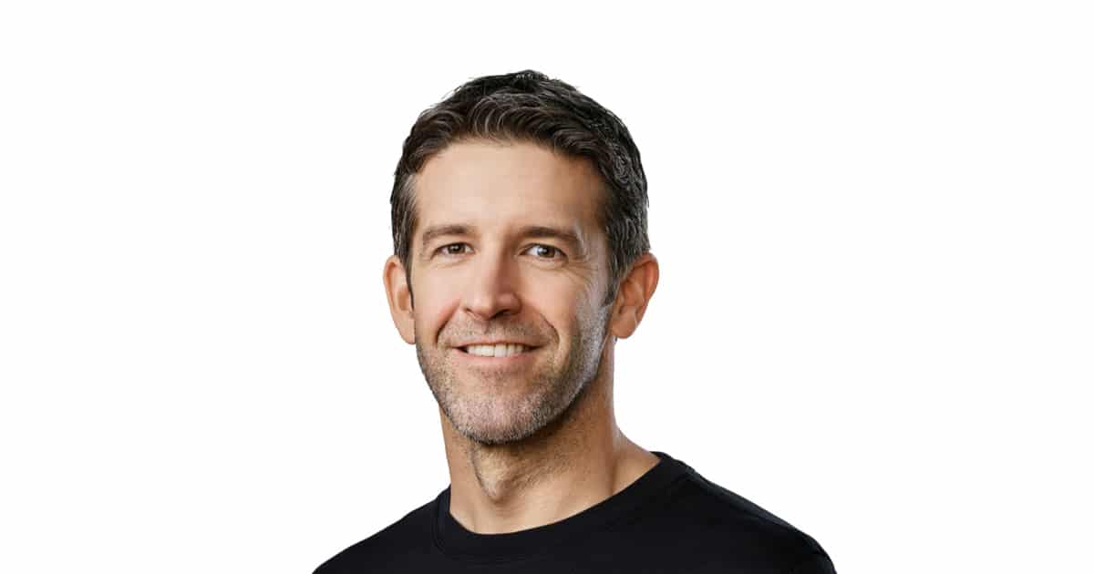 Portrait of a smiling man against a white background.