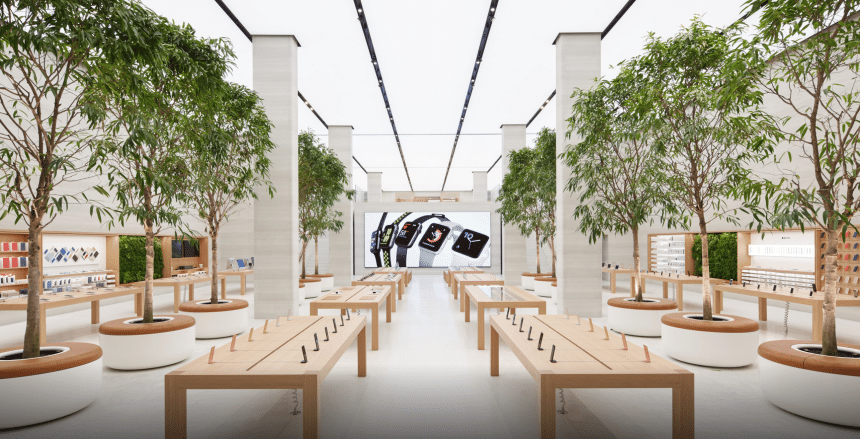 Apple Regent Street store interior with display tables and trees.