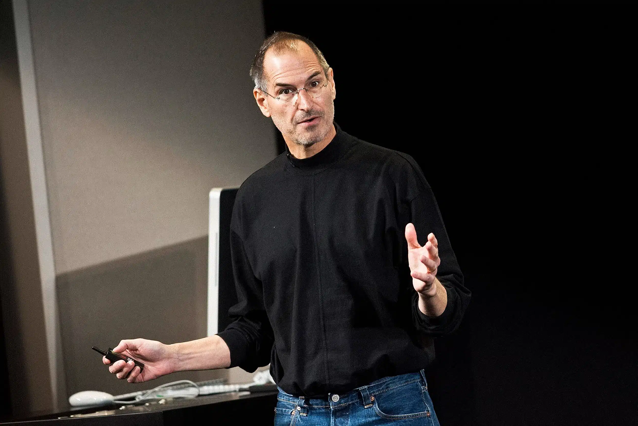 Man giving a presentation while holding a remote.