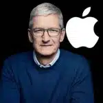 Tim Cook standing beside the Apple logo.