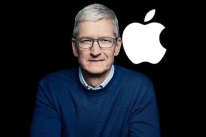 Tim Cook standing beside the Apple logo.