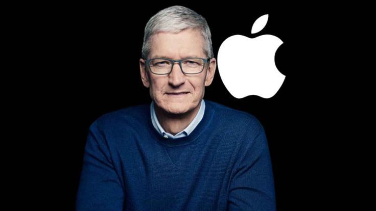 Tim Cook standing beside the Apple logo.