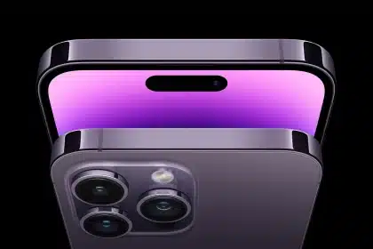 Close-up of an iPhone with triple rear cameras and a purple display.