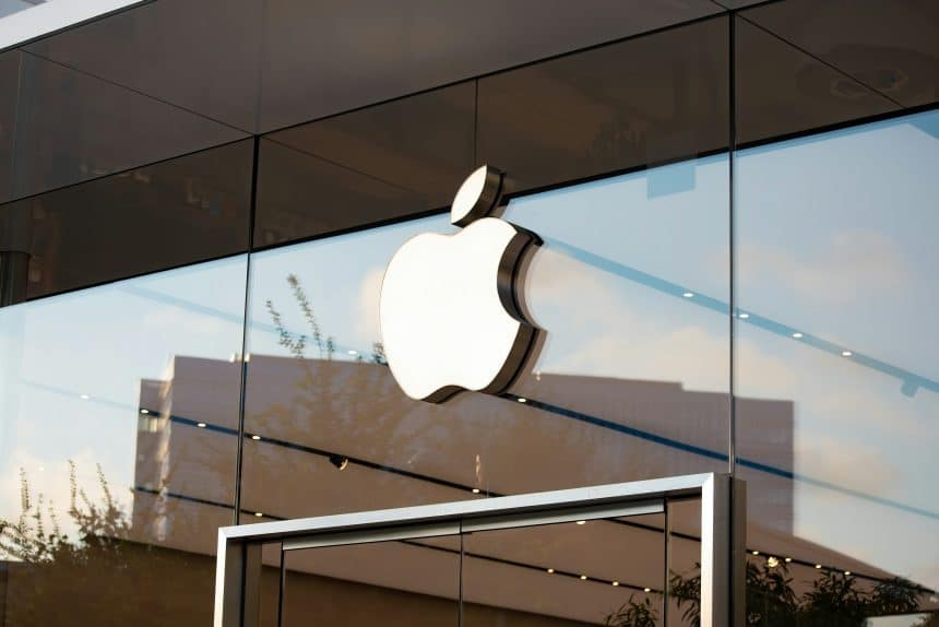 Apple logo displayed on the glass exterior of an Apple Store.