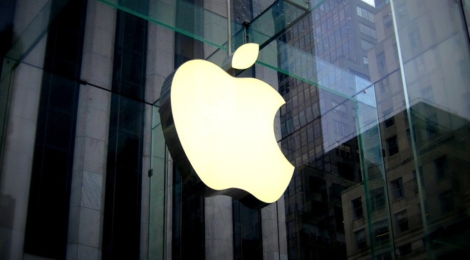 Apple logo displayed on the glass exterior of an Apple Store building.