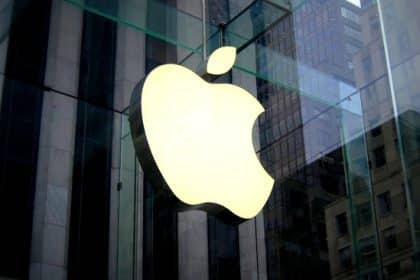 Apple logo displayed on the glass exterior of an Apple Store building.