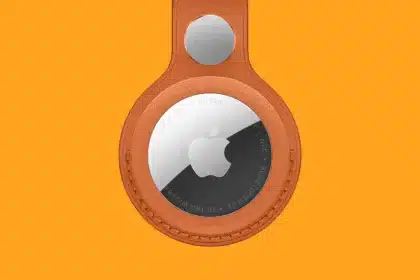 Apple AirTag in an orange leather holder.