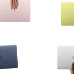 Four colourful MacBook laptops held by hands against a clean background.