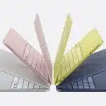 Four colourful MacBook Neo laptops displayed in a fan-like arrangement.