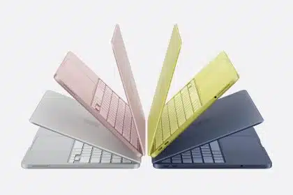 Four colourful MacBook Neo laptops displayed in a fan-like arrangement.