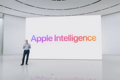 Apple executive presenting “Apple Intelligence” on a large screen in a modern auditorium.