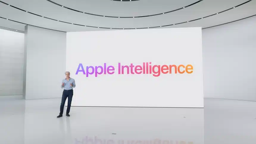 Apple executive presenting “Apple Intelligence” on a large screen in a modern auditorium.