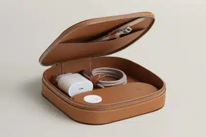 Leather travel case with wireless charger and cable inside.