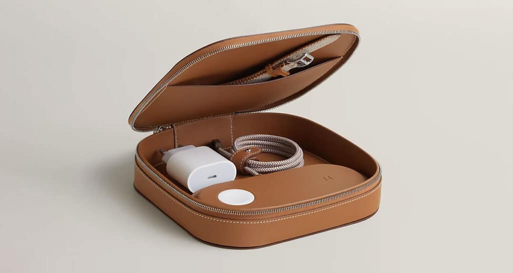 Leather travel case with wireless charger and cable inside.
