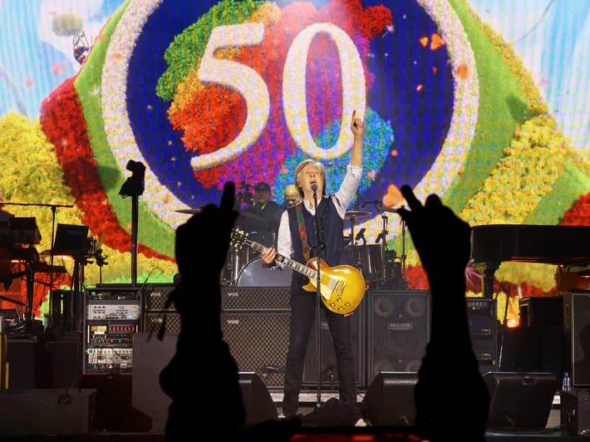 Paul McCartney performing on stage with a guitar during Apple&rsquo;s 50th anniversary celebration.