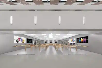 Apple retail store interior with display tables and products.
