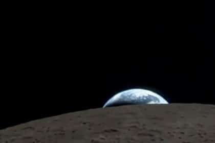 Earth rising over the Moon’s horizon in space.