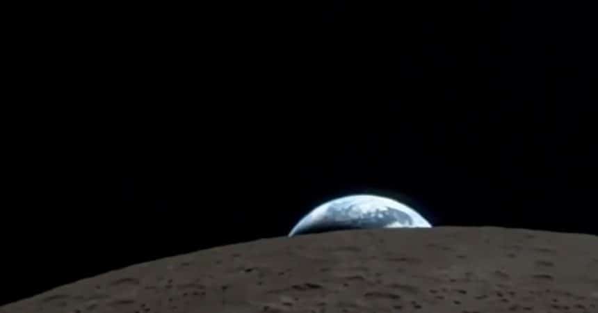 Earth rising over the Moon&rsquo;s horizon in space.