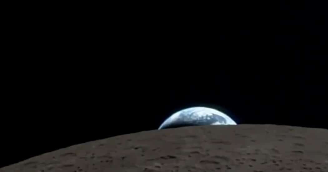 Earth rising over the Moon&rsquo;s horizon in space.