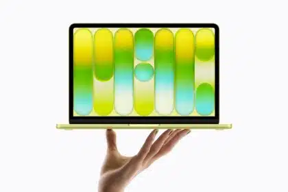 MacBook Neo displayed on a hand with colourful screen design.
