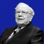 Portrait of Warren Buffett speaking against a blue background