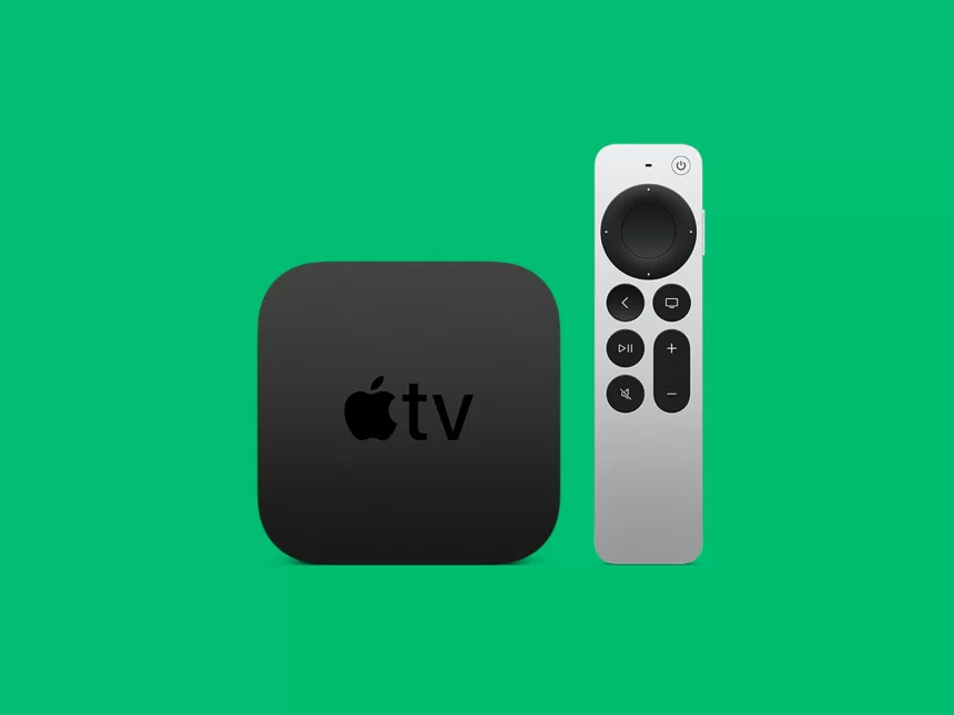 Apple TV box with remote on green background.