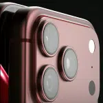 Close-up of a red iPhone with triple camera lenses.