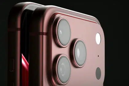 Close-up of a red iPhone with triple camera lenses.