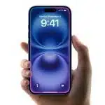 Hand holding an iPhone displaying the home screen.