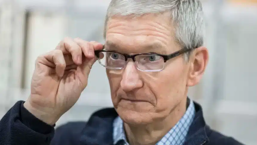 Man wearing glasses adjusting them with a focused expression.