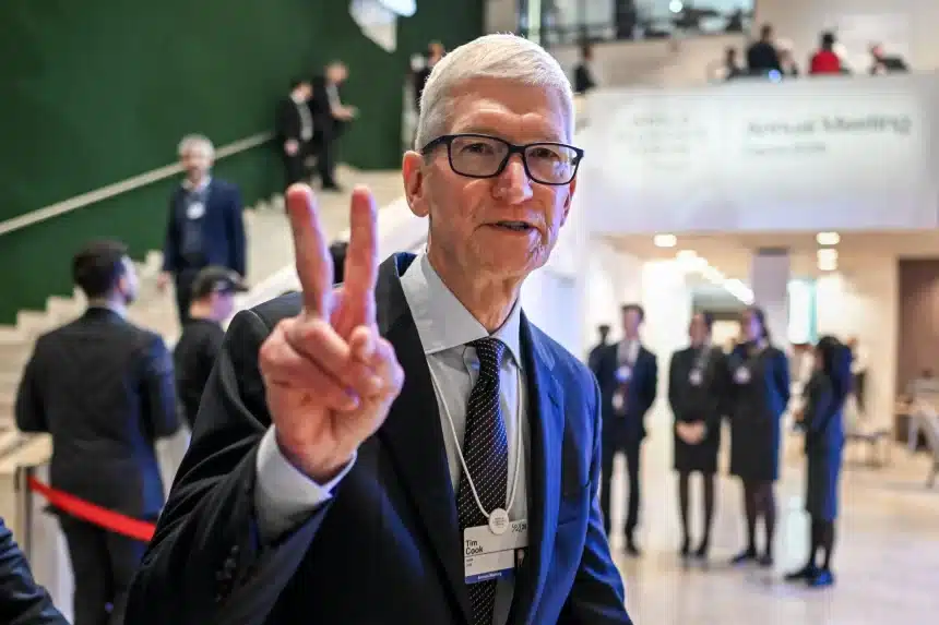 Tim Cook making a peace sign at an event.