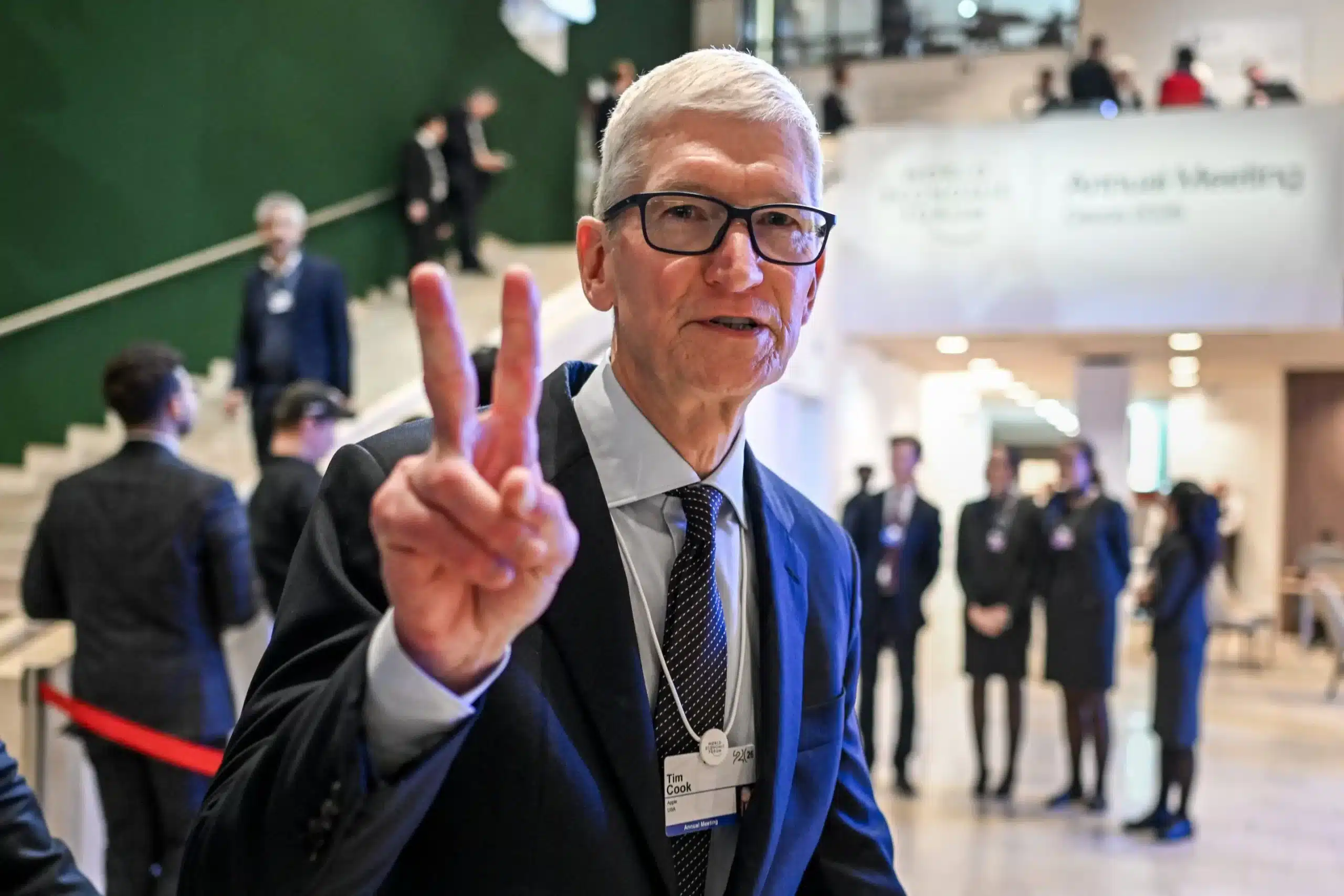 Tim Cook making a peace sign at an event.