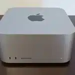 Apple Mac mini on a wooden desk.