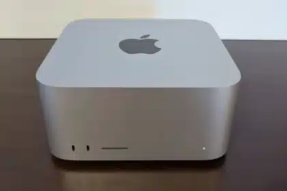 Apple Mac mini on a wooden desk.