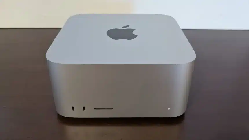 Apple Mac mini on a wooden desk.