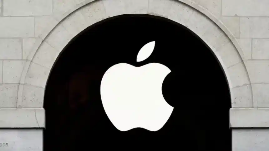 Apple logo on a black sign within a stone archway.