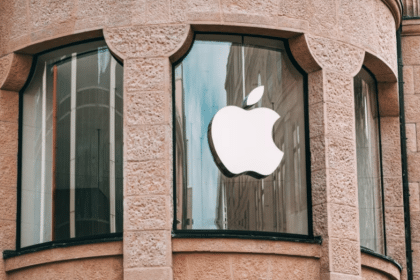 Apple logo displayed on a storefront window.