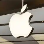 Apple logo hanging inside a modern retail store.