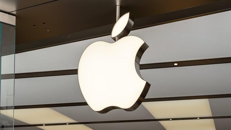 Apple logo hanging inside a modern retail store.