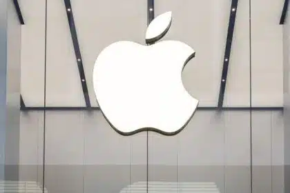 Large white Apple logo displayed on a modern glass storefront.